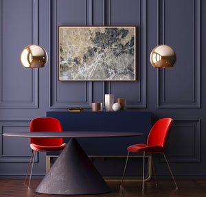 Abstract art photography with levels of brown, black, and white colors in a sophisticated room with a purple table, red chairs, purple luxury wall, and hanging golden light.