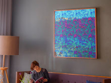 Load image into Gallery viewer, We Are One is an abstract landscape artwork featuring the ocean and trees in blues and some pinks placed on topic of a large sofa in a room.