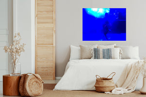 The blue abstract art inspires people to experience release for resilience into joy, depth, and expansion. The art is located in a bedroom above the bed.